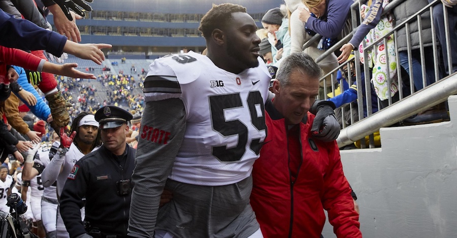 Nov 25, 2017; Ann Arbor, MI, USA; Ohio State Buckeyes offensive lineman Isaiah Prince (59) and head coach Urban Meyer walk off the field after defeating the Michigan Wolverines 31-20 at Michigan Stadium. Mandatory Credit: Rick Osentoski-USA TODAY Sports