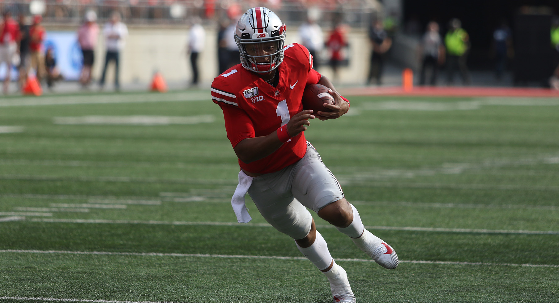 Justin Fields of the Ohio State Buckeyes looks on in the first