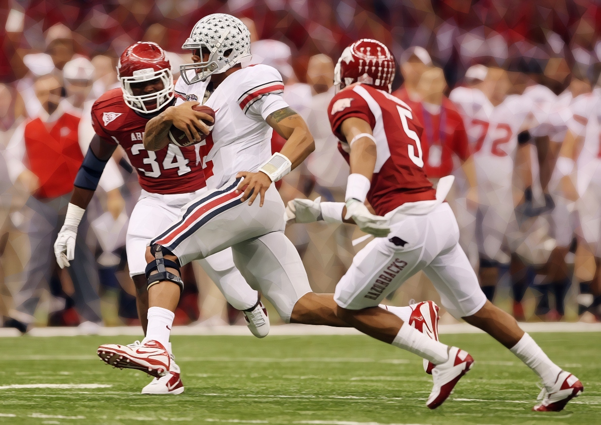 (NCL_OSU_11_SUGAR_LAURON 04JAN11) Ohio State Buckeyes quarterback Terrelle Pryor (2) slips around the Arkansas Razorbacks defense during first half of the Sugar Bowl at the Louisiana Superdome in New Orleans, January 4, 2011. (Dispatch photo by Neal C. Lauron) Ncl Osu 11 Sugar 0025