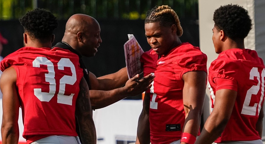 Aug 1, 2024; Columbus, OH, USA; Ohio State Buckeyes running backs coach Carlos Locklyn works with running backs TreVeyon Henderson (32), Quinshon Judkins (1) and James Peoples (20) during football camp at the Woody Hayes Athletic Complex.