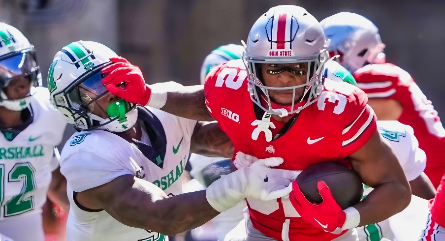 Sep 21, 2024; Columbus, Ohio, USA; Ohio State Buckeyes running back TreVeyon Henderson (32) still arms Marshall Thundering Herd linebacker Landyn Watson (9) in the second half at Ohio Stadium on Saturday.