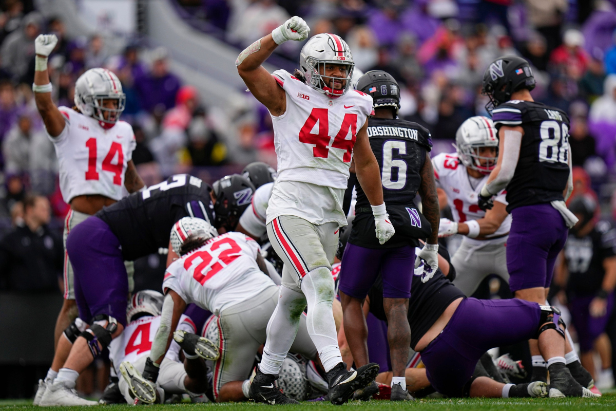 Nov 5, 2022; Evanston, Illinois, USA; Ohio State Buckeyes defensive end J.T. Tuimoloau (44) celebrates a stop during the second half of the NCAA football game against the Northwestern Wildcats at Ryan Field. Ohio State won 21-7. Mandatory Credit: Adam Cairns-The Columbus Dispatch Ncaa Football Ohio State Buckeyes At Northwestern Wildcats