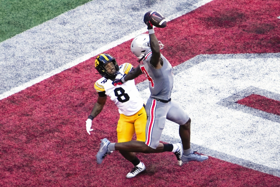 Oct 5, 2024; Columbus, Ohio, USA; Ohio State Buckeyes wide receiver Jeremiah Smith (4) makes a one-handed touchdown catch against Iowa Hawkeyes defensive back Deshaun Lee (8) in the third quarter at Ohio Stadium. Mandatory Credit: Samantha Madar/USA TODAY Network via Imagn Images