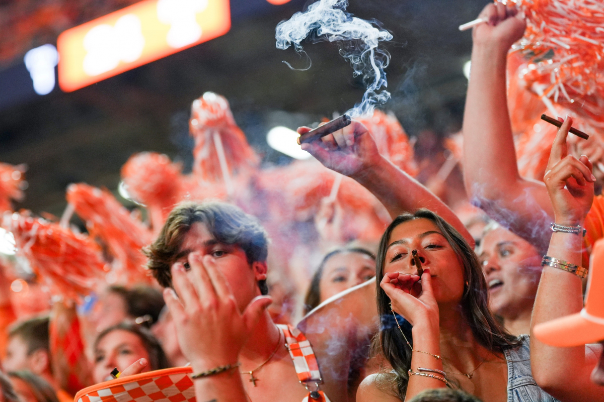 Tennessee students light up cigars after an SEC conference game between Tennessee and Alabama in Neyland Stadium on Saturday, Oct. 19, 2024.