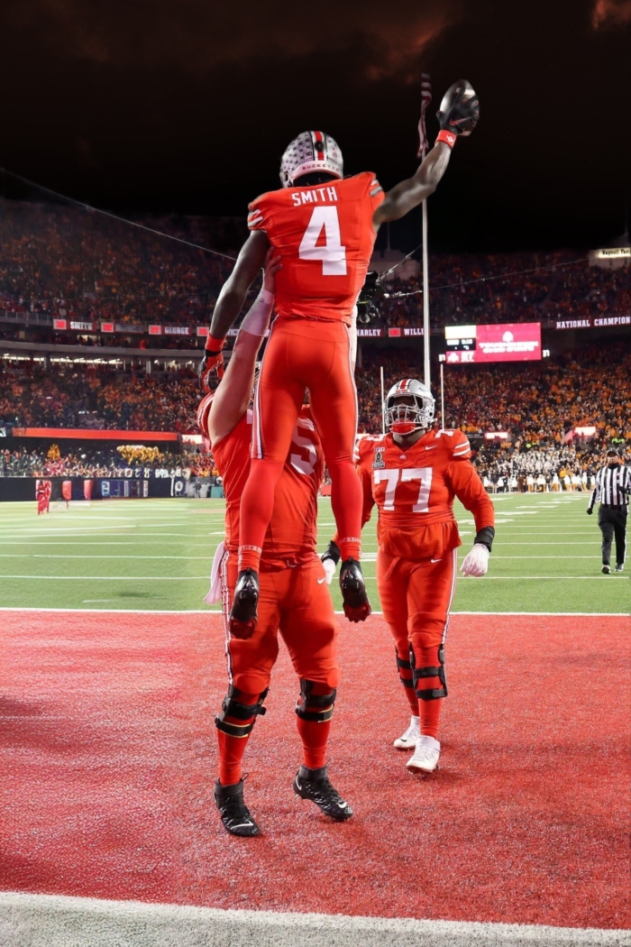 Dec 21, 2024; Columbus, Ohio, USA; Ohio State Buckeyes wide receiver Jeremiah Smith (4) celebrates his touchdown during the third quarter against the Tennessee Volunteers at Ohio Stadium. Mandatory Credit: Joseph Maiorana-Imagn Images