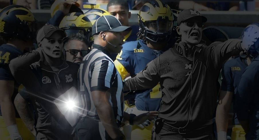 Connor Stalions, left, stands next to Michigan coach Jim Harbaugh during the team's game against Rutgers, Sept. 23, 2023 at Michigan Stadium in Ann Arbor.