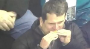 Jim Harbaugh eating a hot dog like a creep.