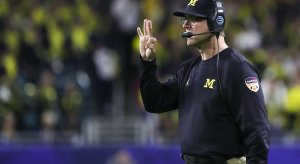  Dec 30, 2016; Miami Gardens, FL, USA; Michigan Wolverines head coach Jim Harbaugh (center) signals from the sideline in the second quarter against the Florida State Seminoles at Hard Rock Stadium. Mandatory Credit: Logan Bowles-USA TODAY Sports