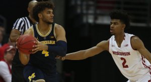 Wisconsin forward Aleem Ford defends Michigan's Isaiah Livers