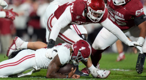 Oklahoma Sooners defensive lineman Ethan Downs and Alabama Crimson Tide quarterback Jalen Milroe