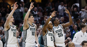 Michigan State players celebrating on the bench