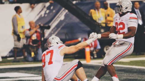 Adolphus Washington of Ohio, helps Florida native Joey Bosa to his feet.