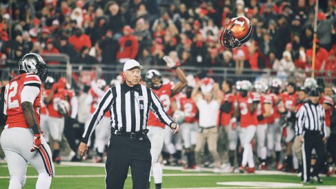 Adolphus Washington watches an Illini helmet take flight