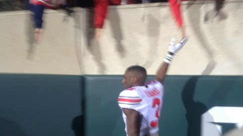 Michael Thomas exchanges high fives after Ohio State defeated Michigan State.