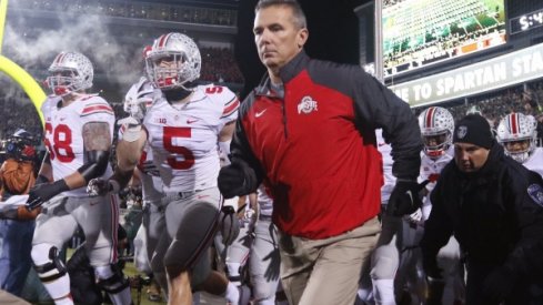 Urban Meyer and the Buckeyes take the field in East Lansing