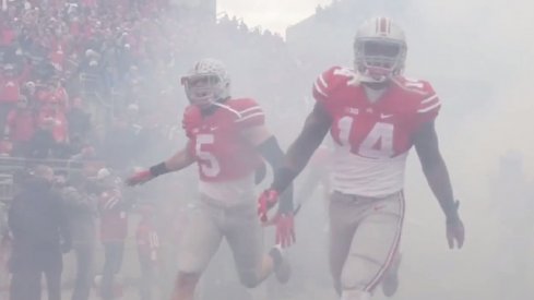 Jeff Heuerman and Curtis Grant bust through the smoke to run onto the Ohio Stadium field.