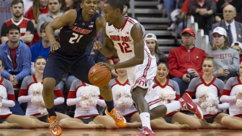 Sam Thompson dribbles past defender.