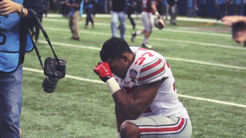 Joshua Perry takes a knee after beating Alabama.