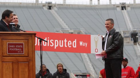 Jeff Heuerman and Urban Meyer hold the new sign, The Undisputed Way