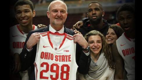 Thad Matta holds up a jersey with No. 298 on it, signifying the number of wins he's amassed as Ohio State's head coach.