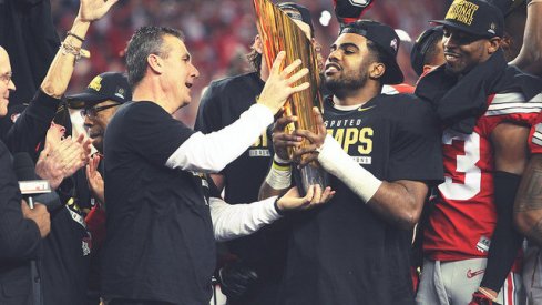 Urban Meyer and Ezekiel Elliott holding the world's first CFP trophy.