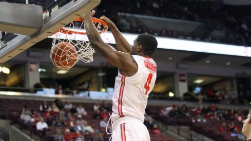 Daniel Giddens slams home a dunk against Walsh.