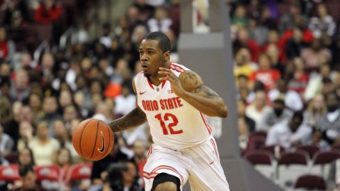 A.J. Harris brings the ball up the floor.