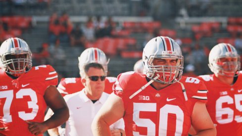 Jacoby Boren leads Ohio State onto the field.