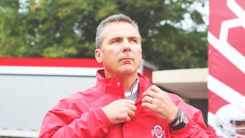 Urban Meyer stands in the rain.