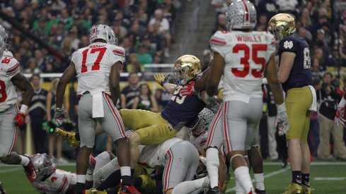 Jerome Baker, Chris Worley make tackles against Notre Dame. 