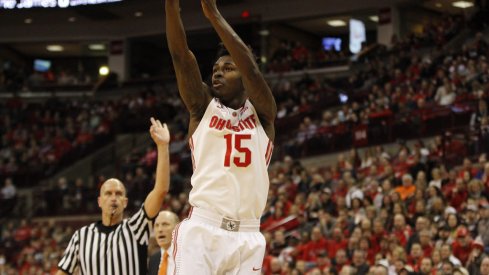 Kam Williams hoists a jumper against Illinois.