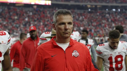 Urban Meyer walks off the field following Ohio State's Fiesta Bowl win.