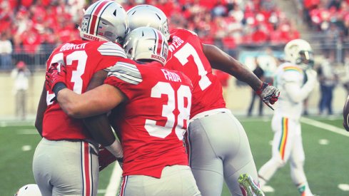 Dante Booker, Craig Fada and Damon Webb celebrate a special teams play against Hawai'i.