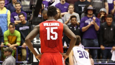 Kam Williams looks on as Northwestern shoots a free throw Wednesday night.