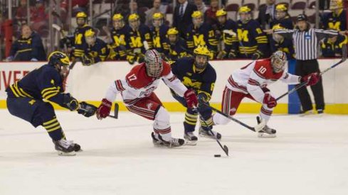 John Wiitala watches Dave Gust sprint ahead of the Michigan defense