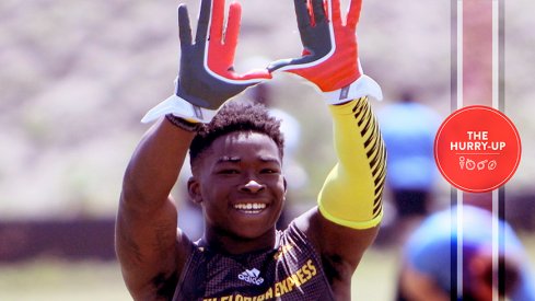 Sam Bruce throwing up "The U" at a 7-on-7 tournament.