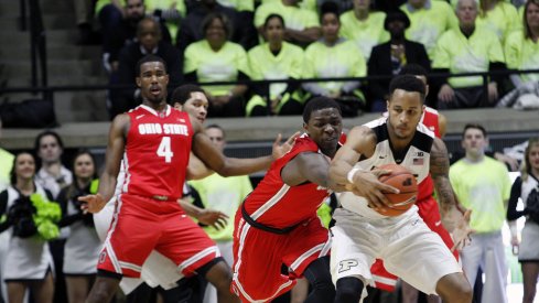 Jae'Sean Tate battles for a loose ball against Purdue.