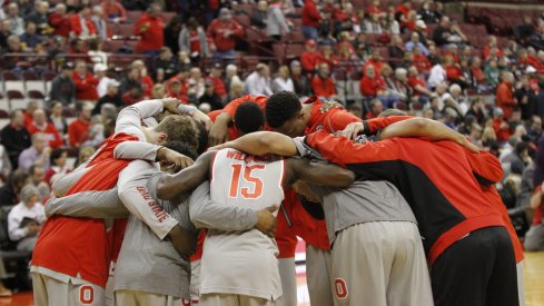 The Buckeyes huddle up before the tip against their rivals.