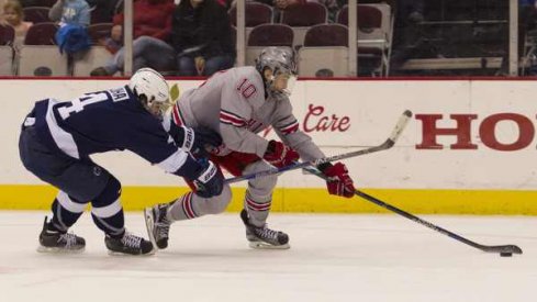 Ohio State's John Wiitala protects the puck from Luke Juha of Penn State