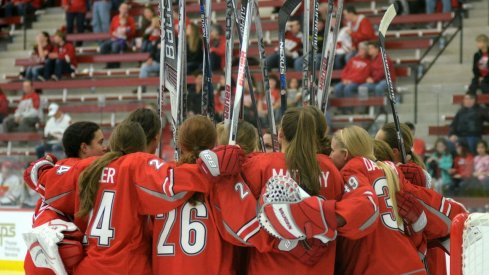 Ohio State women's hockey players huddle up before the opening faceoff.