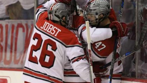 Mason Jobst and Josh Healey celebrate a goal for Ohio State men's hockey.