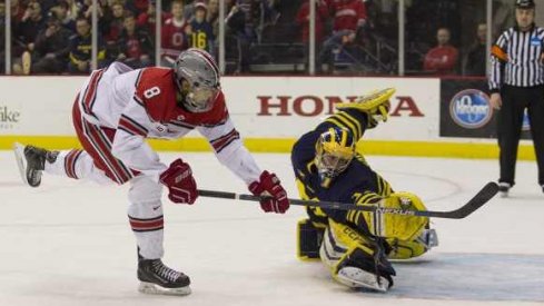 Ohio State forward Dakota Joshua wins the shootout with a goal against Michigan goalie Steve Racine.