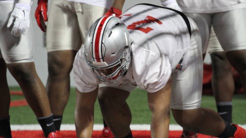 Michael Hill working with the first-team defensive tackles Tuesday during spring practice.