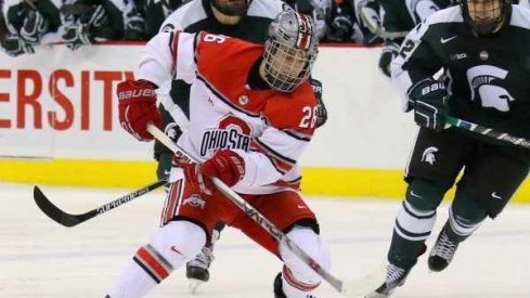 Ohio State forward Mason Jobst controls the puck against the Michigan State Spartans.