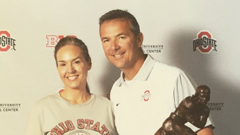 Kristin Conrad and Urban Meyer pose for a photo at the Ohio State Football Women's Clinic