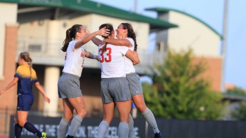 Women's soccer celebrates victory.