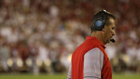 Urban Meyer strolls the sidelines in Norman.