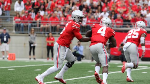 J.T. Barrett hands off to Curtis Samuel against Rutgers.