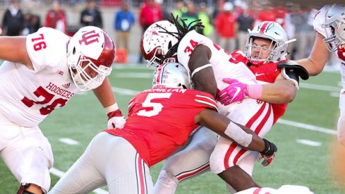 Nick Bosa and Raekwon McMillan combine for a tackle for a loss against Indiana.