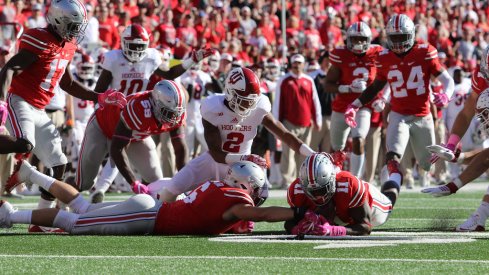 Jalyn Holmes and Sam Hubbard dive for a fumble against Indiana. 